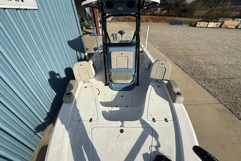 Slide: The Image of 2024 Sea Pro 230 Bay boat, white deck, blue console, outdoor setting. - 50