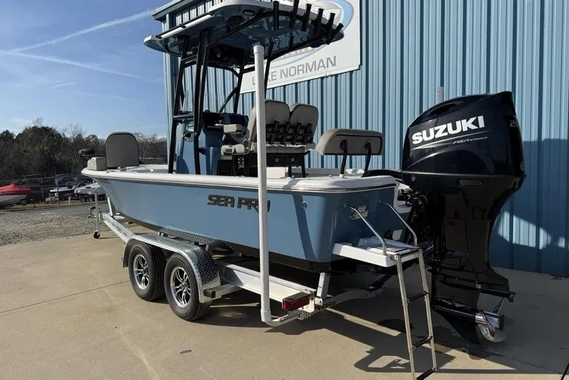 Slide: The Image of 2024 Sea Pro 230 Bay boat with Suzuki engine on trailer, parked outdoors. - 7
