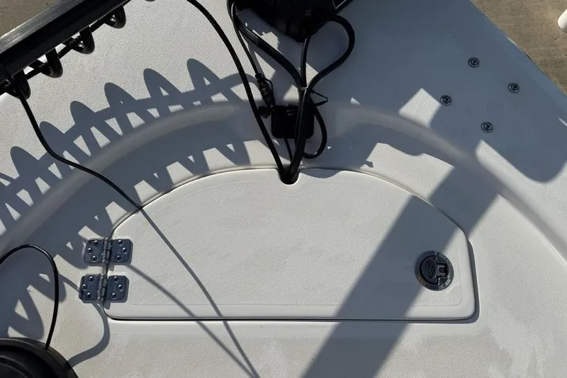 Slide: The Image of 2024 Sea Pro 230 Bay boat deck with hatch and cables visible. - 9