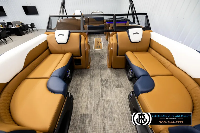 Slide: The Image of Luxurious interior of 2026 Avalon LSZ ELW pontoon boat with tan and navy seating. - 13