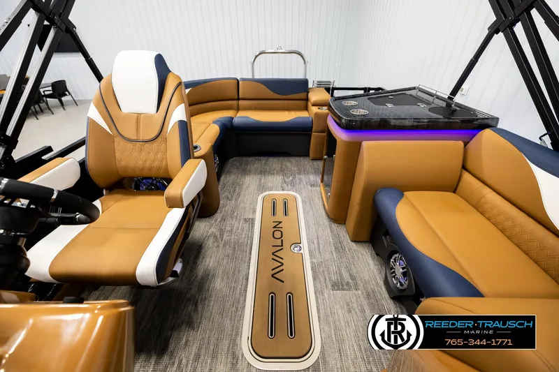 Slide: The Image of Luxurious interior of 2026 Avalon LSZ ELW pontoon boat with tan and navy seating. - 14