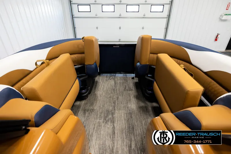 Slide: The Image of 2026 Avalon LSZ ELW boat interior with tan and blue seating in a showroom. - 19