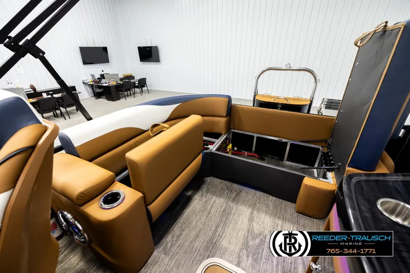 Slide: The Image of 2026 Avalon LSZ ELW boat interior with tan seating and storage compartments. - 21