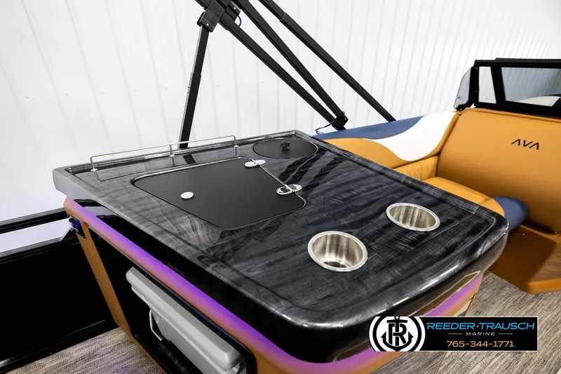 Slide: The Image of 2026 Avalon LSZ ELW boat interior with sleek bar area and cup holders. - 22