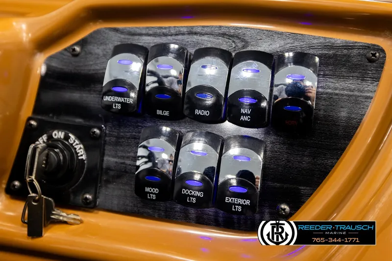 Slide: The Image of Control panel of 2026 Avalon LSZ ELW boat with labeled switches and ignition keys. - 32