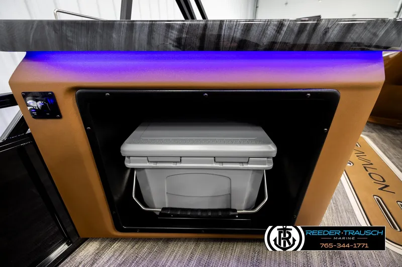 Slide: The Image of 2026 Avalon LSZ ELW boat interior with cooler storage and ambient lighting. - 37