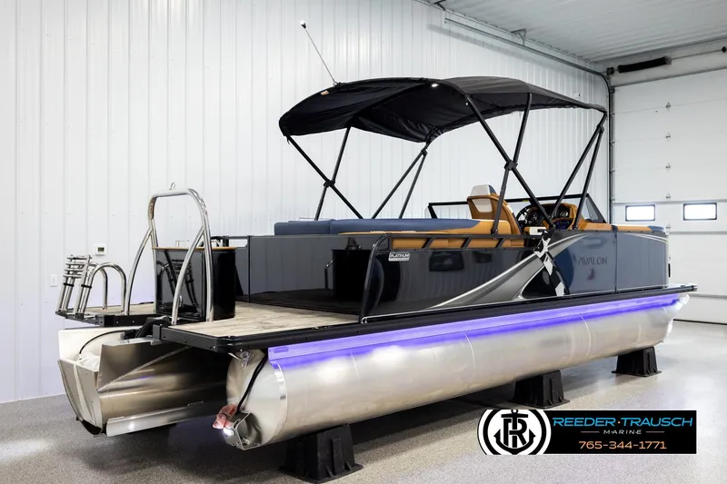 Slide: The Image of 2026 Avalon LSZ ELW pontoon boat in showroom with canopy and modern design. - 6