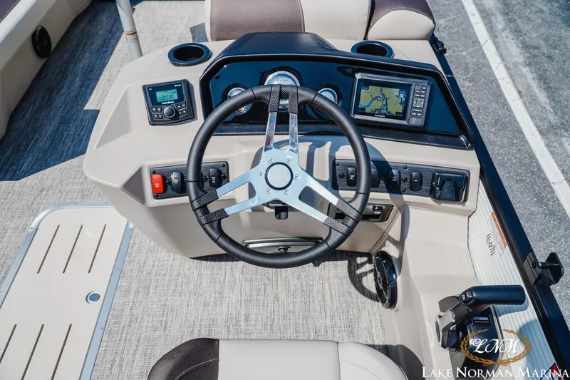 Slide: The Image of 2026 Bennington 22SSR boat dashboard with steering wheel and navigation controls. - 6