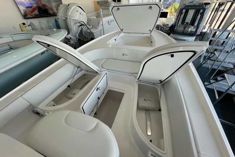 Slide: The Image of 2026 Contender 26 Bay boat interior with open storage compartments in showroom. - 10