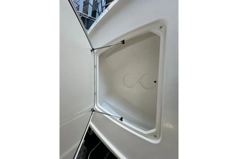 Slide: The Image of Open storage compartment on 2026 Contender 26 Bay boat, showcasing interior design. - 11