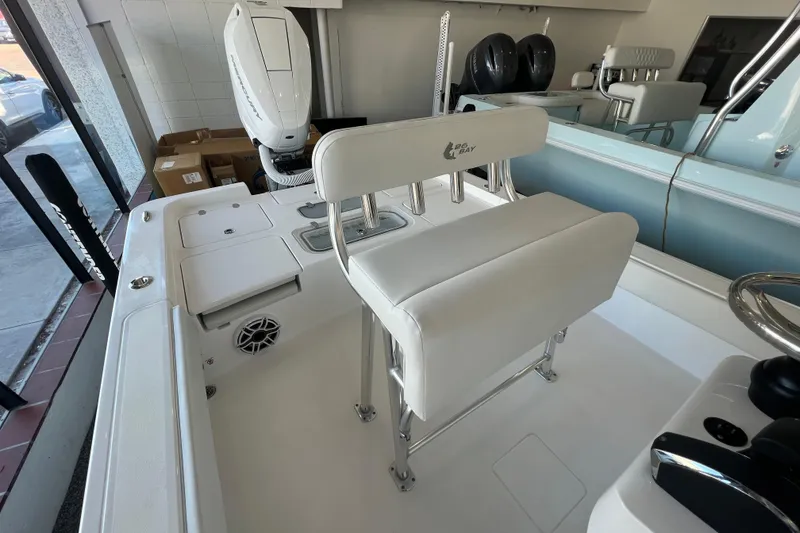 Slide: The Image of 2026 Contender 26 Bay boat interior with seating and motor, showroom display. - 6