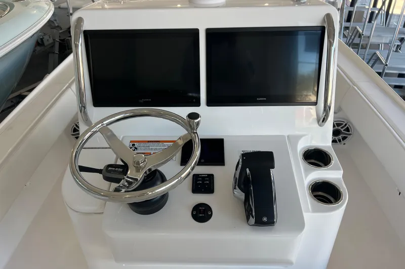 Slide: The Image of 2026 Contender 26 Bay boat console with dual screens and steering wheel. - 7