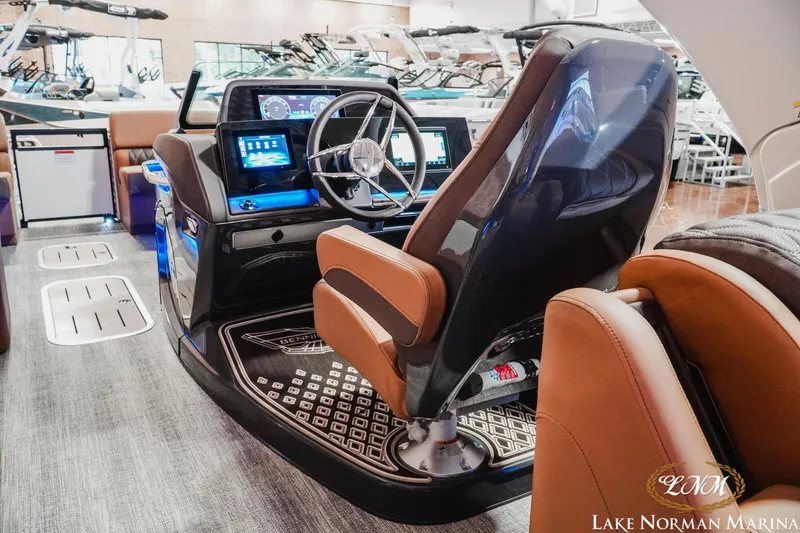 Slide: The Image of 2026 Bennington 25QFBA boat interior with modern dashboard and steering at Lake Norman Marina. - 12