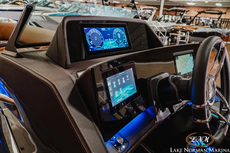 Slide: The Image of 2026 Bennington 25QFBA boat dashboard with advanced digital displays at Lake Norman Marina. - 14