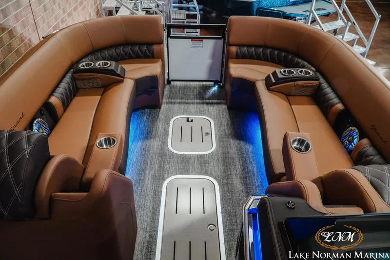 Slide: The Image of 2026 Bennington 25QFBA boat interior with luxurious seating and ambient lighting. - 15