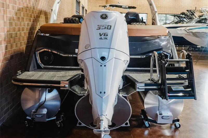 Slide: The Image of 2026 Bennington 25QFBA pontoon boat with powerful 350 V6 engine in showroom. - 16