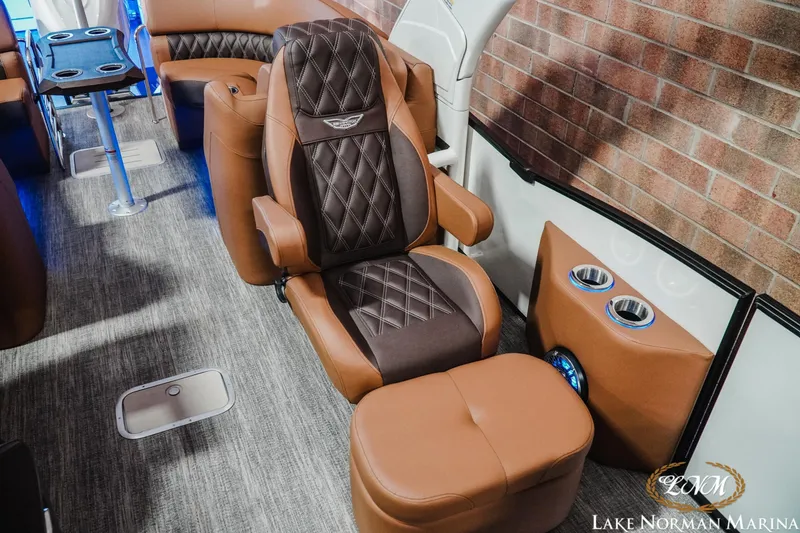Slide: The Image of Luxurious interior of 2026 Bennington 25QFBA boat with plush seating and cup holders. - 9