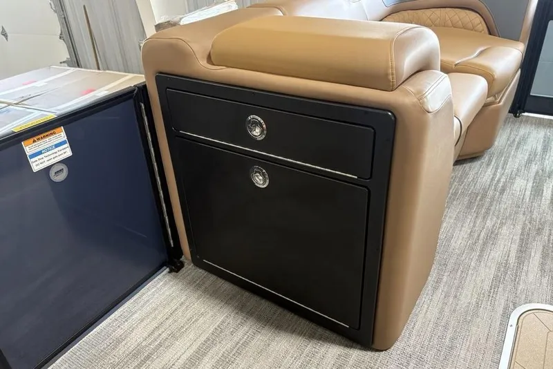 Slide: The Image of 2026 Godfrey Sweetwater 2286 QS interior with tan seating and black storage unit. - 13