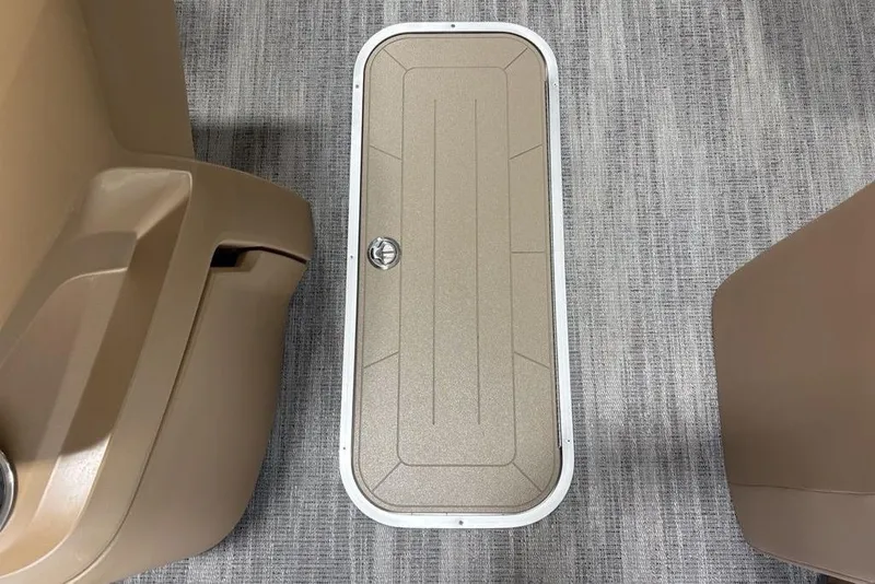 Slide: The Image of 2026 Godfrey Sweetwater 2286 QS boat interior with storage compartment on carpeted floor. - 16