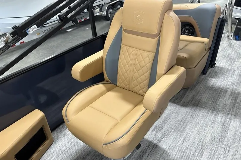 Slide: The Image of Luxurious seating on 2026 Godfrey Sweetwater 2286 QS pontoon boat, featuring tan and gray upholstery. - 18