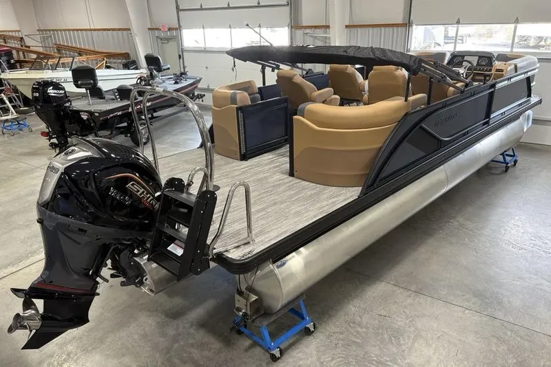 Slide: The Image of 2026 Godfrey Sweetwater 2286 QS pontoon boat with Mercury outboard motor in showroom. - 2