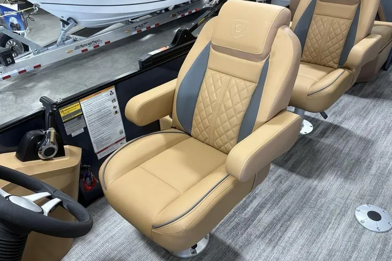 Slide: The Image of Luxurious seating in 2026 Godfrey Sweetwater 2286 QS boat, featuring tan and gray upholstery. - 21