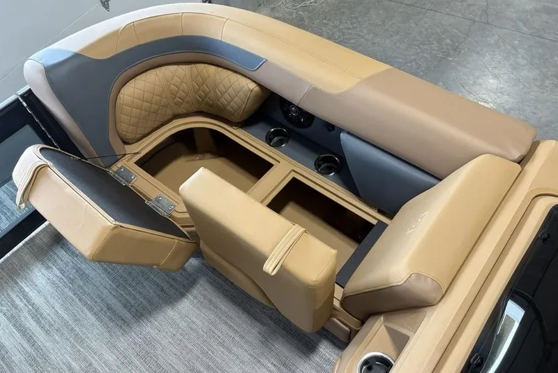 Slide: The Image of 2026 Godfrey Sweetwater 2286 QS boat interior with tan seating and storage compartments. - 4