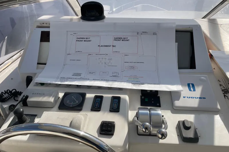 Slide: The Image of Control panel of a 1999 Horizon 70 Motor Yacht with navigation equipment and layout plans. - 34