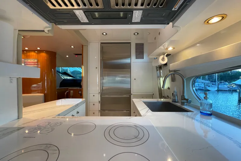 Slide: The Image of Luxurious kitchen interior of a 1999 Horizon 70 Motor Yacht with modern appliances and marina view. - 60