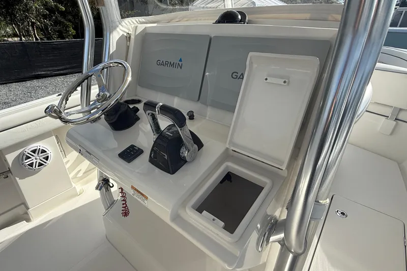 Slide: The Image of 2018 Jupiter 30 boat helm with Garmin navigation system and stainless steel steering wheel. - 10