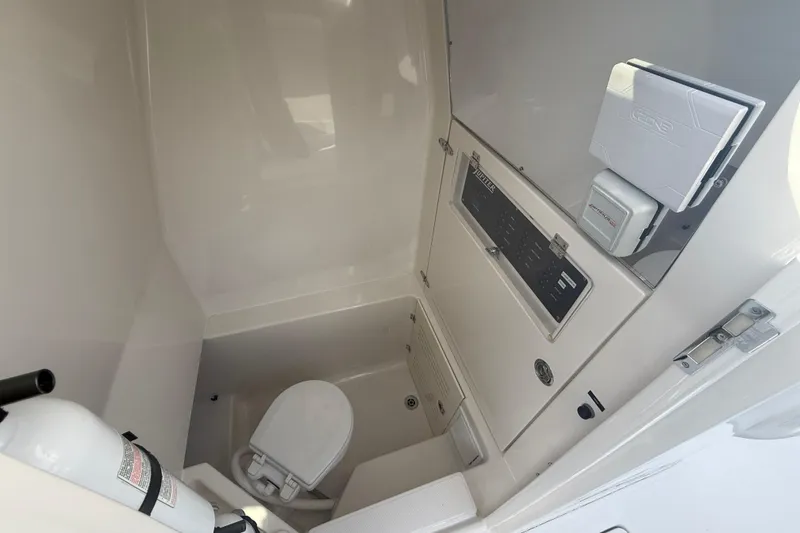 Slide: The Image of Compact bathroom in 2018 Jupiter 30 boat with toilet and fire extinguisher. - 13