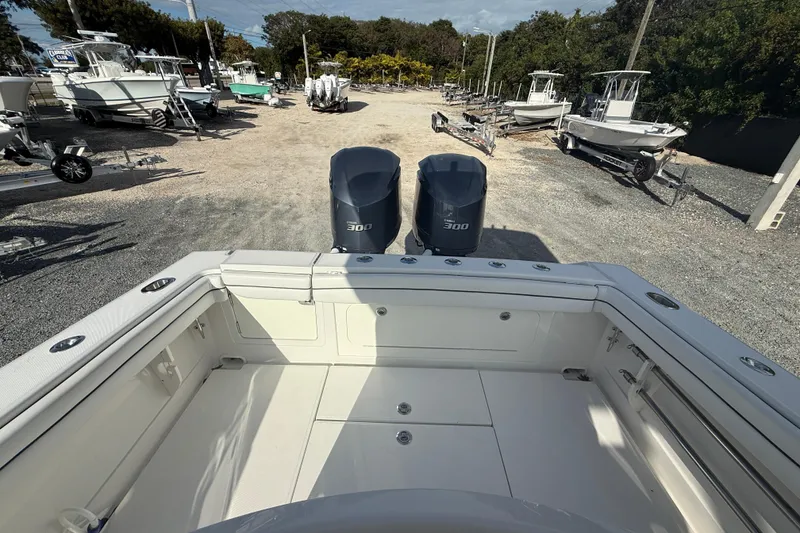 Slide: The Image of 2018 Jupiter 30 boat with dual 300 horsepower engines in a marina setting. - 15