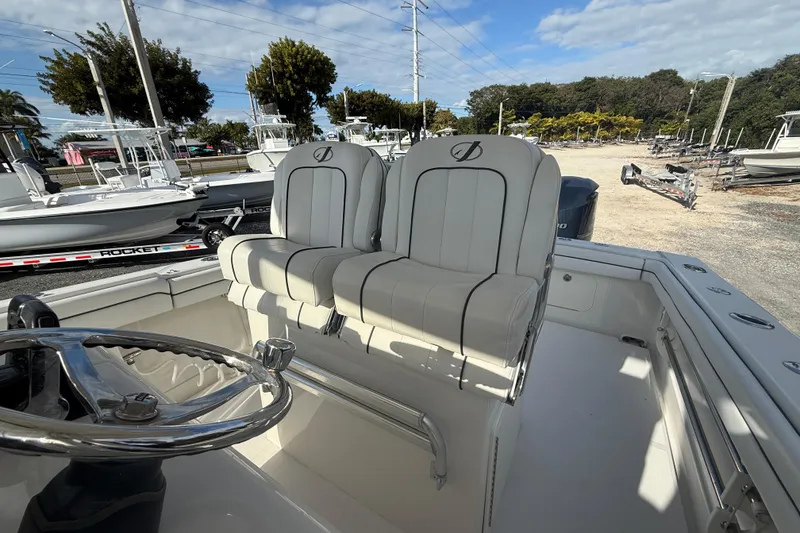 Slide: The Image of 2018 Jupiter 30 boat interior with dual white seats and steering wheel. - 16