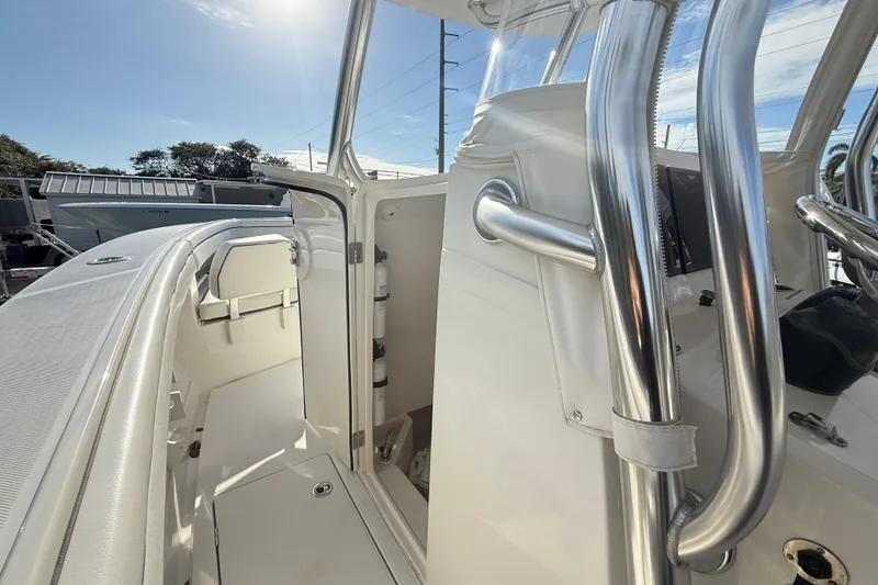 Slide: The Image of 2018 Jupiter 30 boat interior with stainless steel railings and open storage compartment. - 17