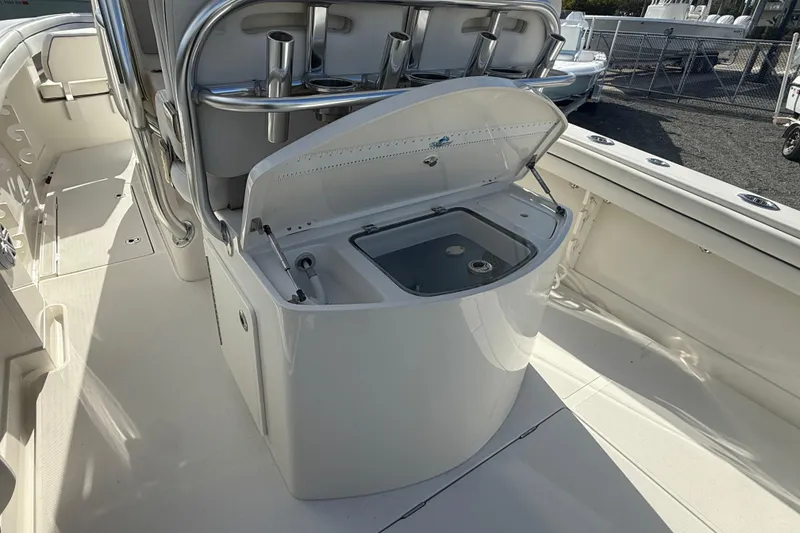 Slide: The Image of 2018 Jupiter 30 boat interior with open storage compartment and rod holders. - 5