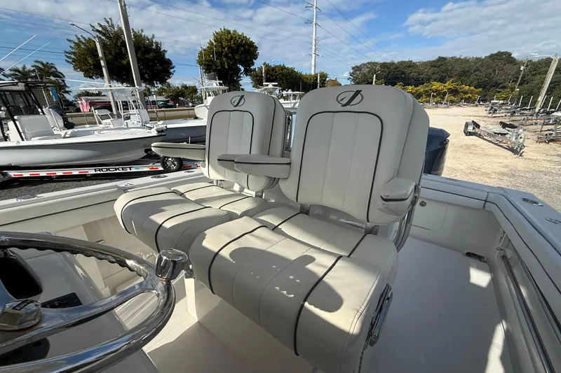 Slide: The Image of 2018 Jupiter 30 boat interior with dual captain's chairs and steering wheel. - 7