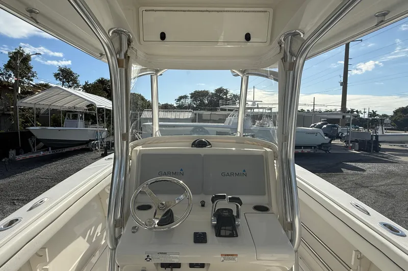 Slide: The Image of 2018 Jupiter 30 boat cockpit with Garmin navigation system, docked under clear skies. - 9