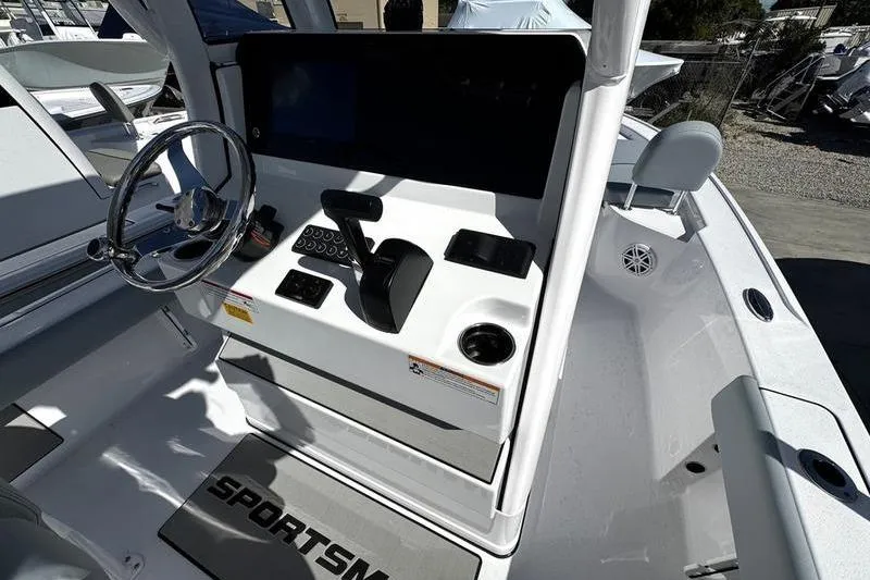 Slide: The Image of 2026 Sportsman Masters 227 Bay Boat cockpit with steering wheel and control panel. - 10