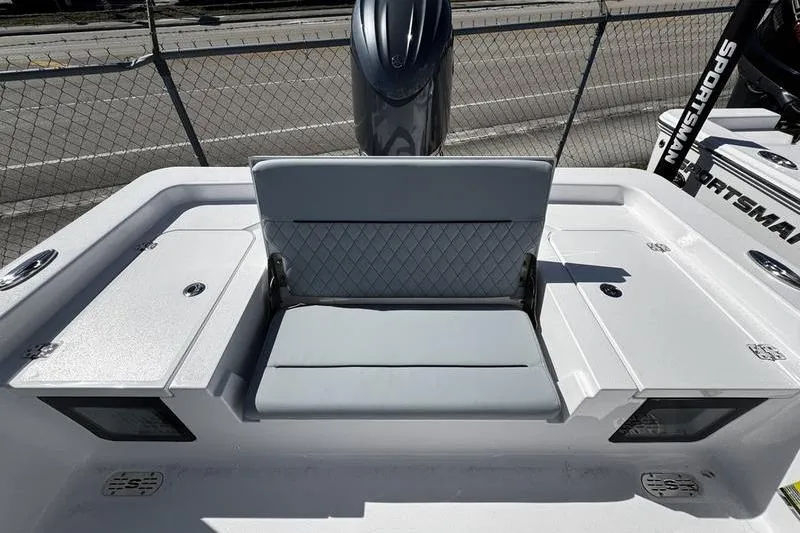 Slide: The Image of 2026 Sportsman Masters 227 Bay Boat with cushioned seating and storage compartments. - 17