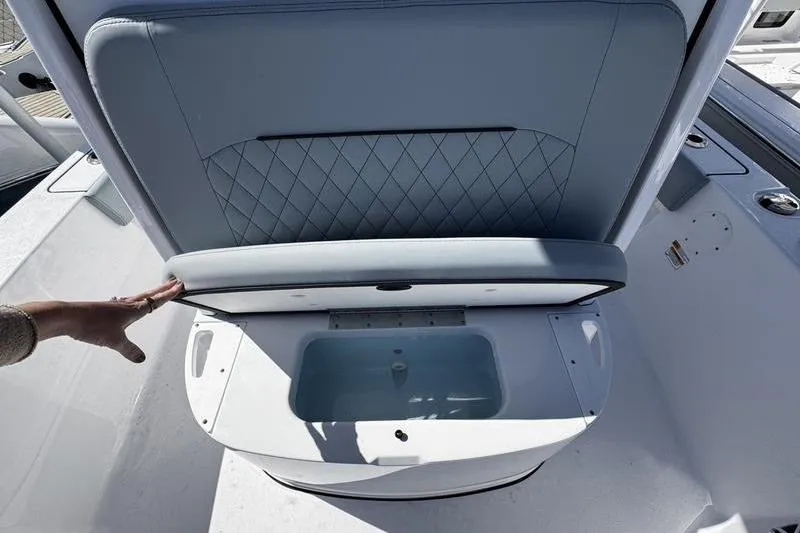 Slide: The Image of 2026 Sportsman Masters 227 Bay Boat seat with storage compartment open. - 7
