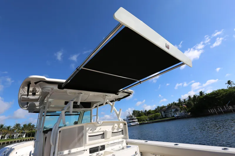 Slide: The Image of 2017 Boston Whaler 370 Outrage boat with extended sunshade on a sunny day. - 19