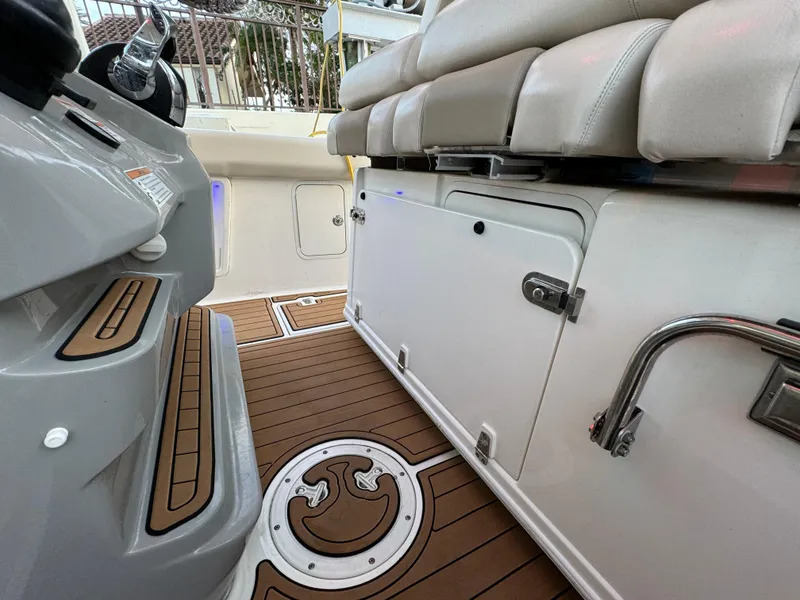 Slide: The Image of 2017 Boston Whaler 370 Outrage interior with cushioned seating and teak flooring. - 21