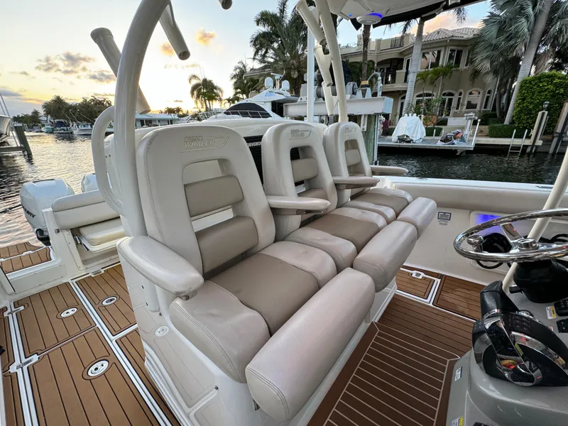 Slide: The Image of 2017 Boston Whaler 370 Outrage boat interior with luxurious seating and waterfront view. - 23