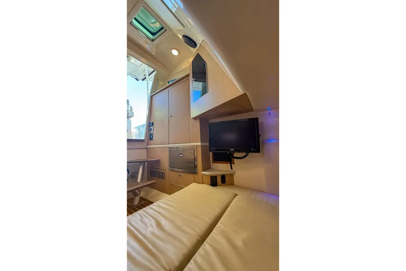 Slide: The Image of Interior cabin of 2017 Boston Whaler 370 Outrage with TV and seating area. - 31