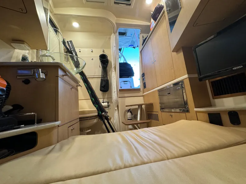 Slide: The Image of Interior cabin of 2017 Boston Whaler 370 Outrage, featuring cozy seating and modern amenities. - 35