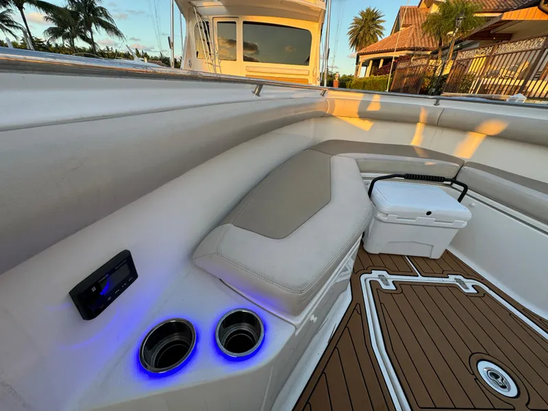 Slide: The Image of 2017 Boston Whaler 370 Outrage interior with cushioned seating and illuminated cup holders. - 39