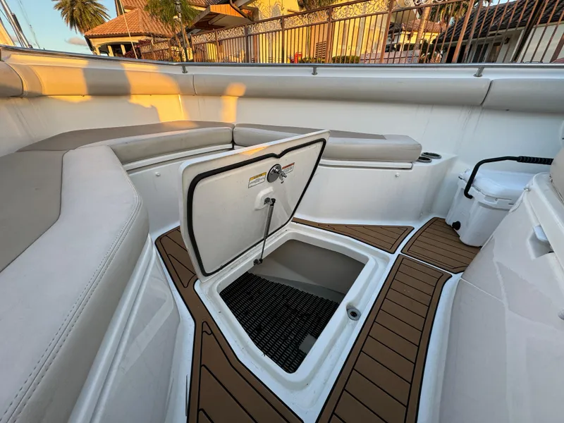 Slide: The Image of 2017 Boston Whaler 370 Outrage interior with open storage compartment and cushioned seating. - 41