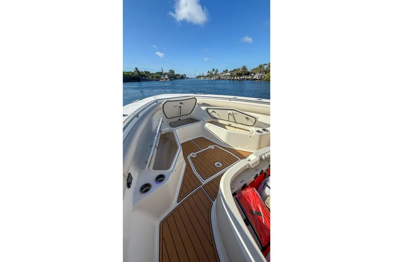 Slide: The Image of 2017 Boston Whaler 370 Outrage boat interior with teak flooring and open storage compartments. - 42