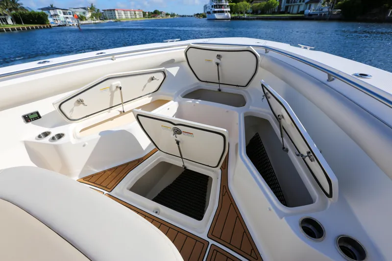 Slide: The Image of 2017 Boston Whaler 370 Outrage boat with open storage compartments on deck. - 43