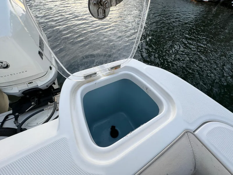 Slide: The Image of Open storage compartment on 2017 Boston Whaler 370 Outrage boat by the water. - 7